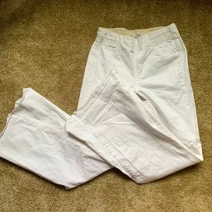 white FREE PEOPLE flared jeans with frayed bottoms and an elastic waistband